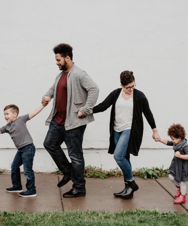 A family of 4 dancing happily